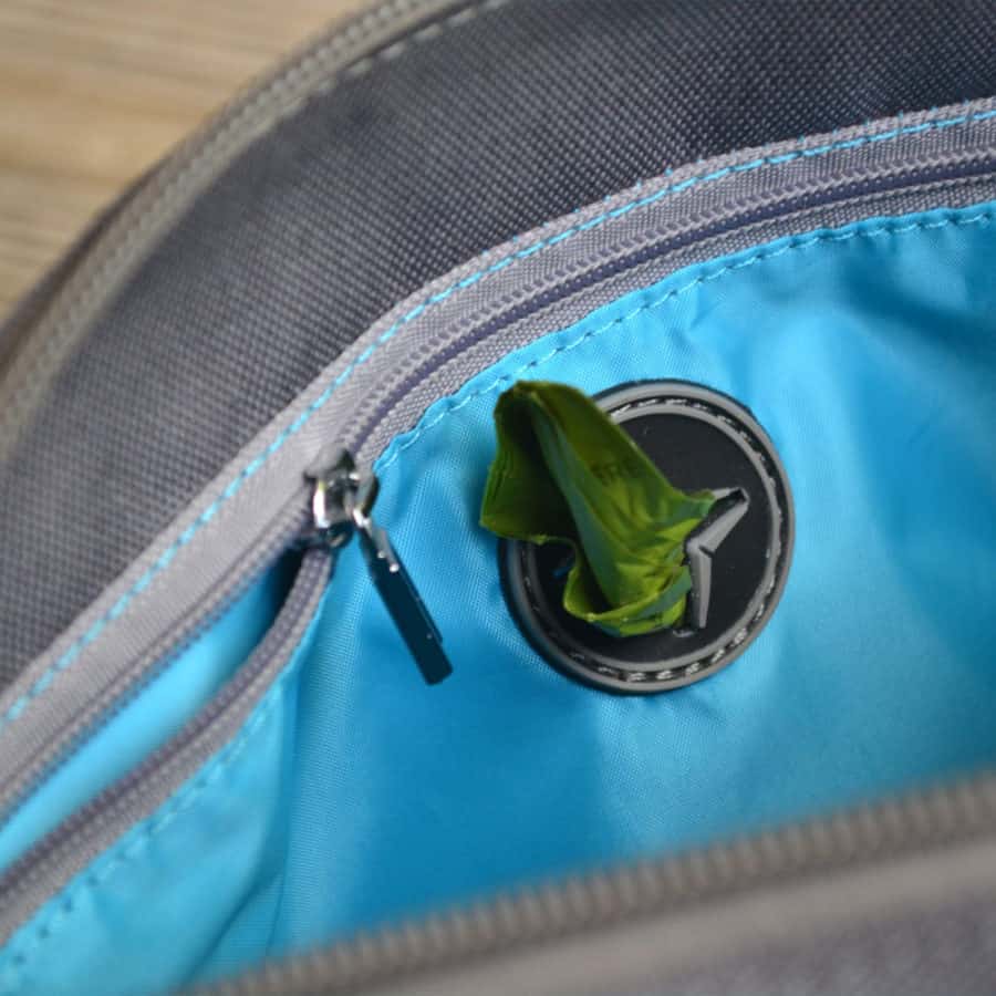 poop bag dispenser on dog walking bag